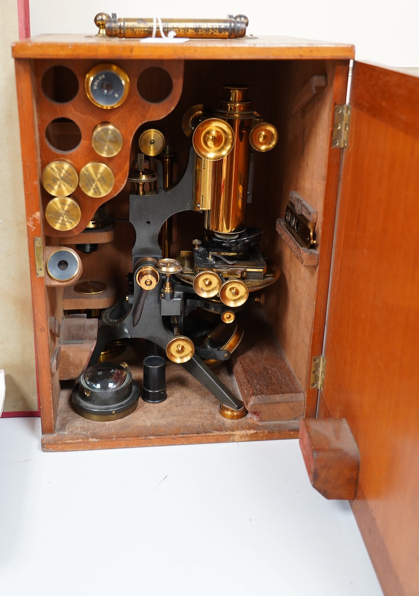 A late 19th/early 20th century brass microscope, by Watson and Sons, in a fitted case with some alternative lenses and other accessories, case 39.5cm high. Condition - fair